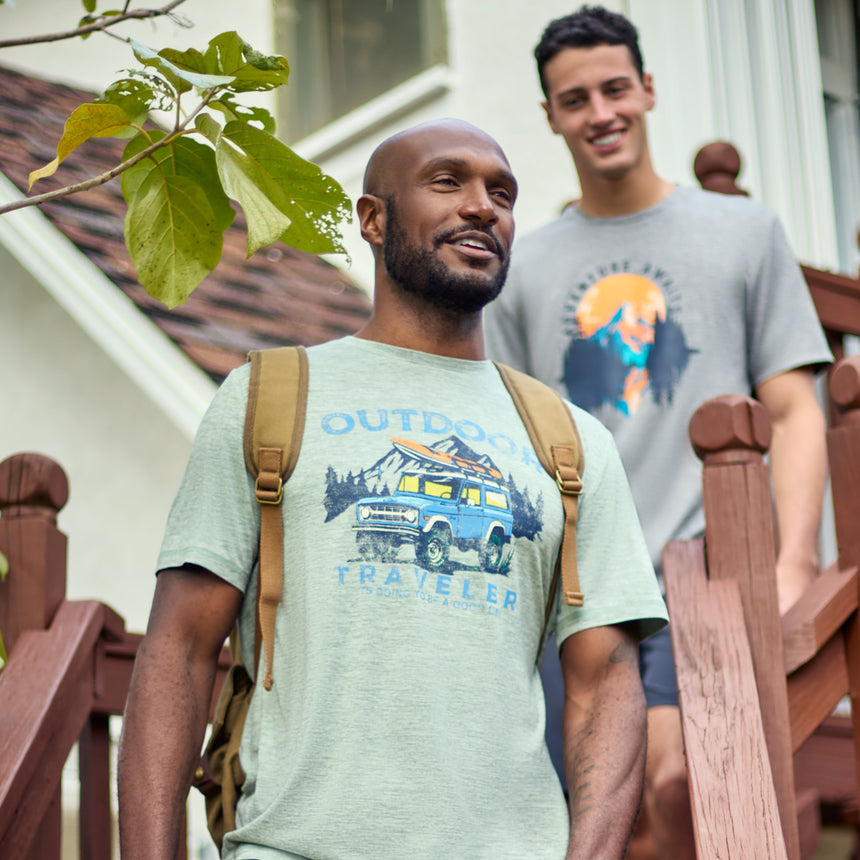 Man wearing Free Country Men's Super Soft Short Sleeve Crew Tee - 2 Pack in Basil, size M, made from anti-odor, breathable lightweight performance fabric featuring a classic active fit, an outdoor traveler design, and a peached finish #color_basil