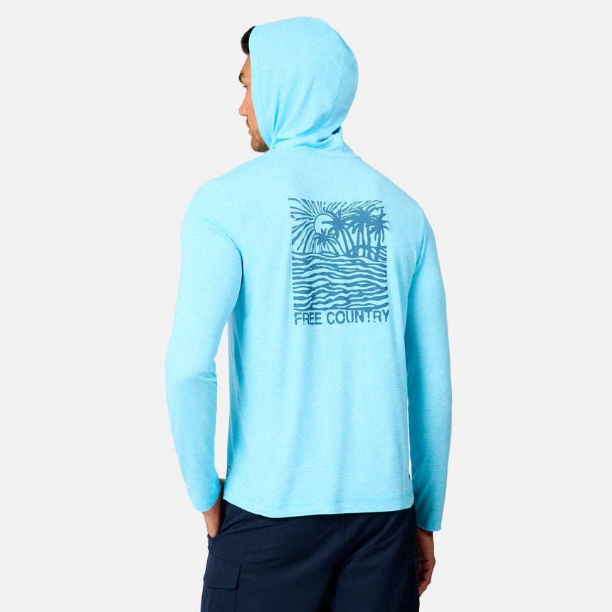 A man wears the Free Country Men's Microtech® Hooded Graphic Sunshirt in light blue with UPF 50+ and a beach scene plus "FREE COUNTRY" on the back, standing against a plain white background.