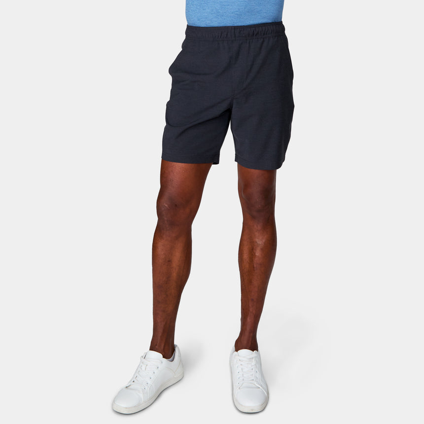 A person wearing Clearance Men's Trek Short and white sneakers stands against a plain light background, with only the lower half of their body visible.