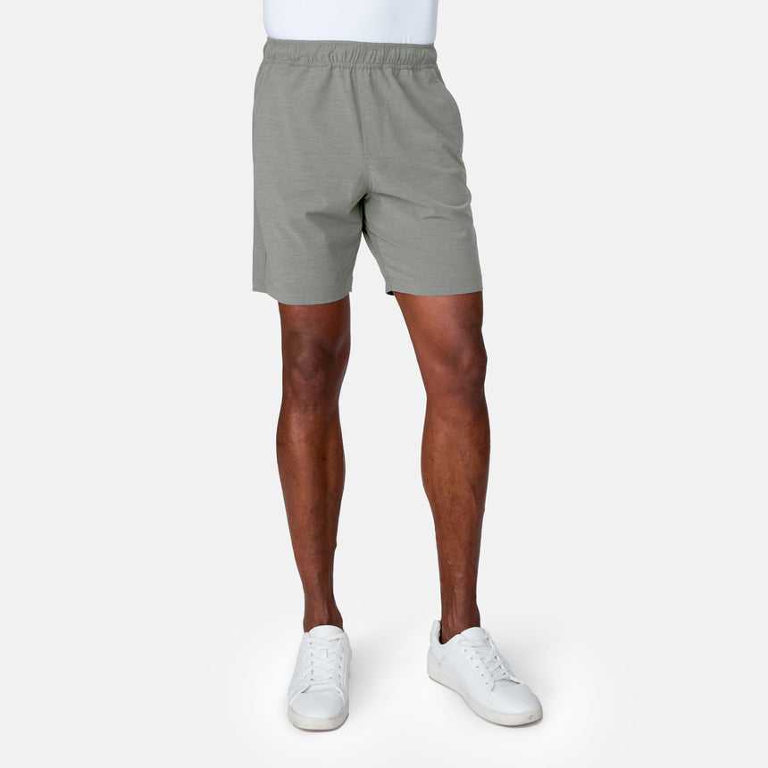 A person wears Clearance Men's Trek Short in light gray, paired with a partially visible white shirt and white sneakers, standing against a plain light gray background. The image displays the model from the waist down.