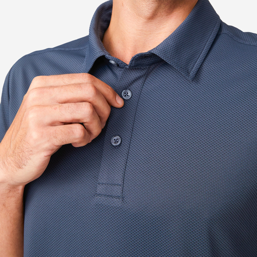 A man buttons up the Clearance Men's Tech Pique Polo Shirt, showing only his lower face and upper torso against a plain white background.