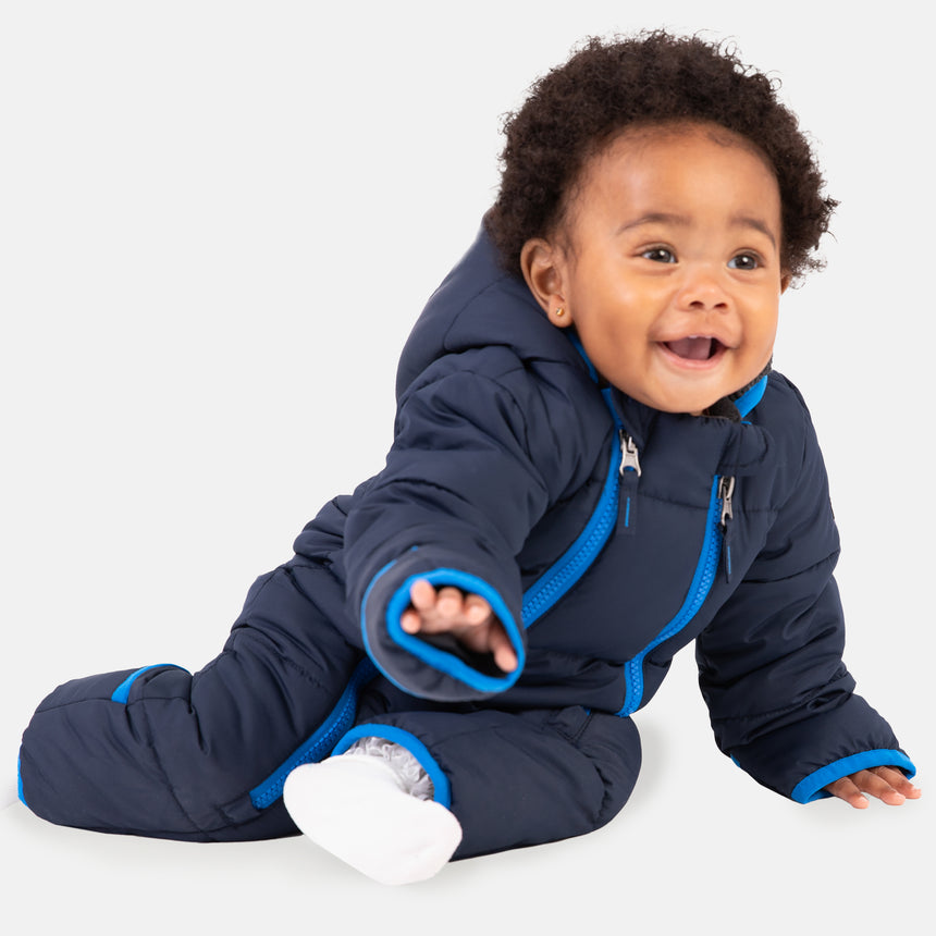Free Country Kids' Infant Lightweight Quilted Puffer Snow Suit in navy, featuring wide channel quilting, sherpa lining, dual zippers, and fold-over mittens and booties for warmth and easy dressing.