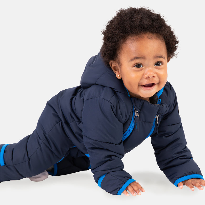 Free Country Kids' Infant Lightweight Quilted Puffer Snow Suit in navy, featuring wide channel quilting, sherpa lining, dual zippers, and fold-over mittens and booties for warmth and easy dressing.