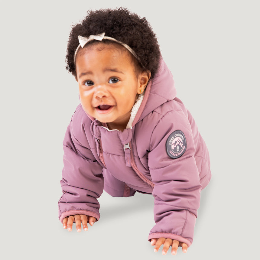 Free Country Kids' Infant Lightweight Quilted Puffer Snow Suit in light purple, featuring wide channel quilting, sherpa lining, dual zippers, and fold-over mittens and booties for warmth and easy dressing.