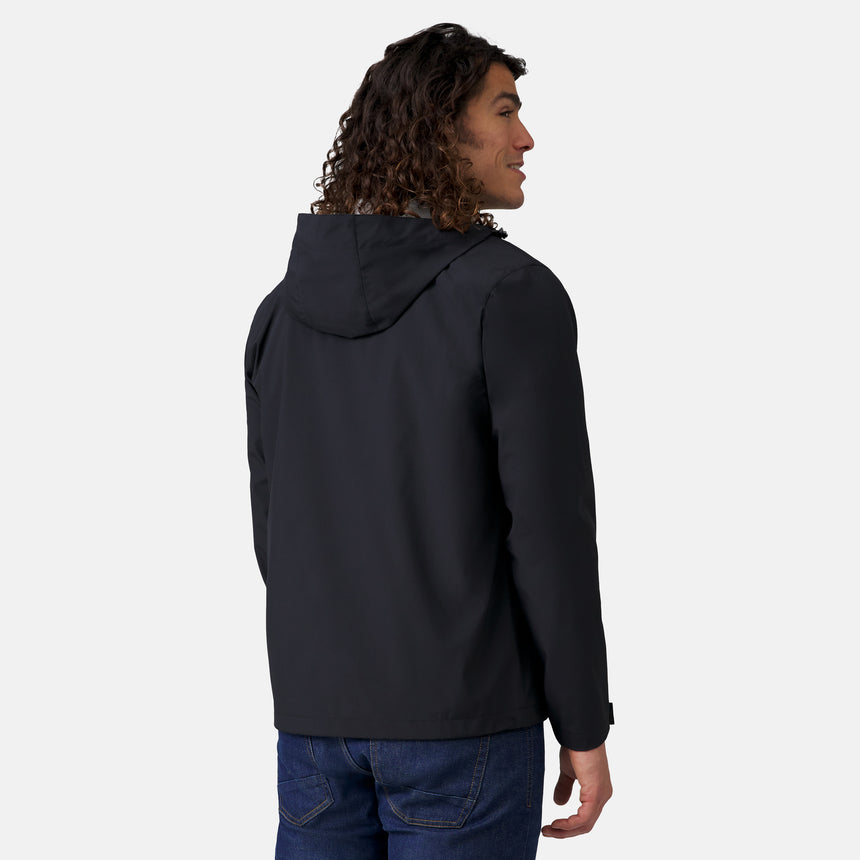 A person with long curly hair is seen from the back, wearing Clearance’s Men's Hydro Lite X2O Highline Waterproof Jacket in black and blue jeans, posed against a plain light background.