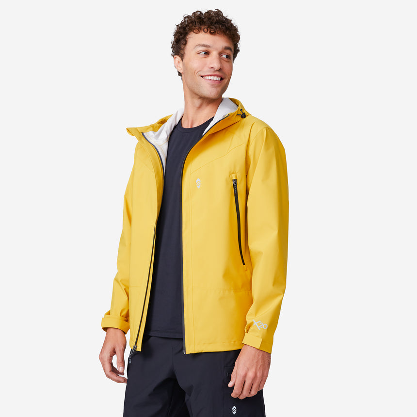 A man smiles and looks left while wearing the Clearance Men's Hydro Lite X2O Squall Rain Jacket over a black shirt, standing against a plain white background.