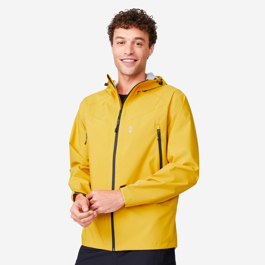 A smiling person with curly hair wears the Clearance Men's Hydro Lite X2O Squall Rain Jacket in bright yellow, featuring black zippers, while standing against a plain white background.