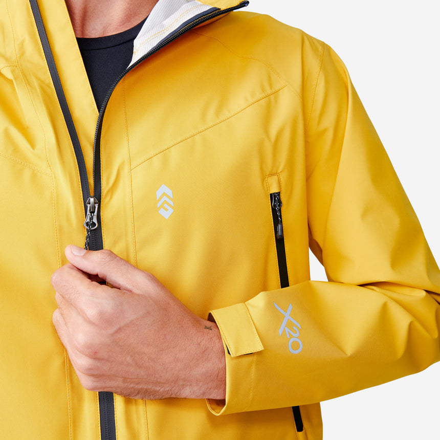 A person zips up the Clearance Men's Hydro Lite X2O Squall Rain Jacket, a bright yellow lightweight rain jacket with black zippers and subtle white logos on the chest and sleeve, shown from the shoulders down.