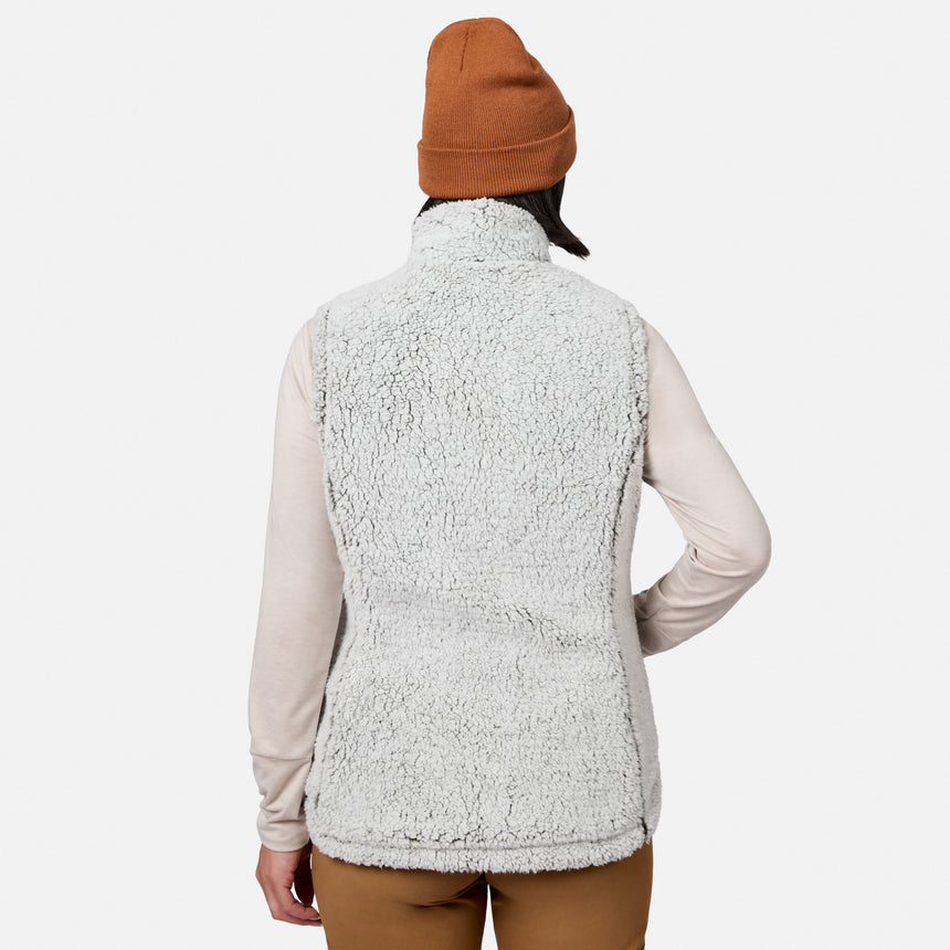 A person, shown from the back against a plain white background, is wearing a brown beanie, a light long-sleeve shirt, and the Free Country Women’s Stratus Lite II Reversible Vest—a fuzzy light gray vest crafted from recycled polyester for lightweight warmth.