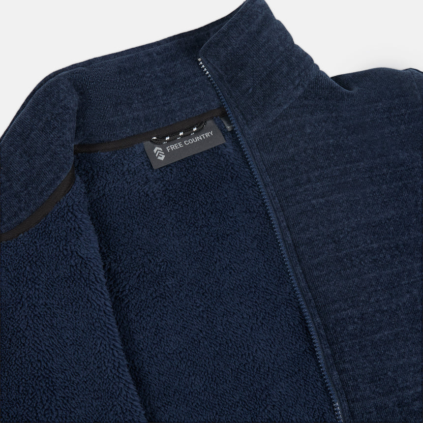 Close up of navy fleece jacket pile lining with Free Country logo on a white background