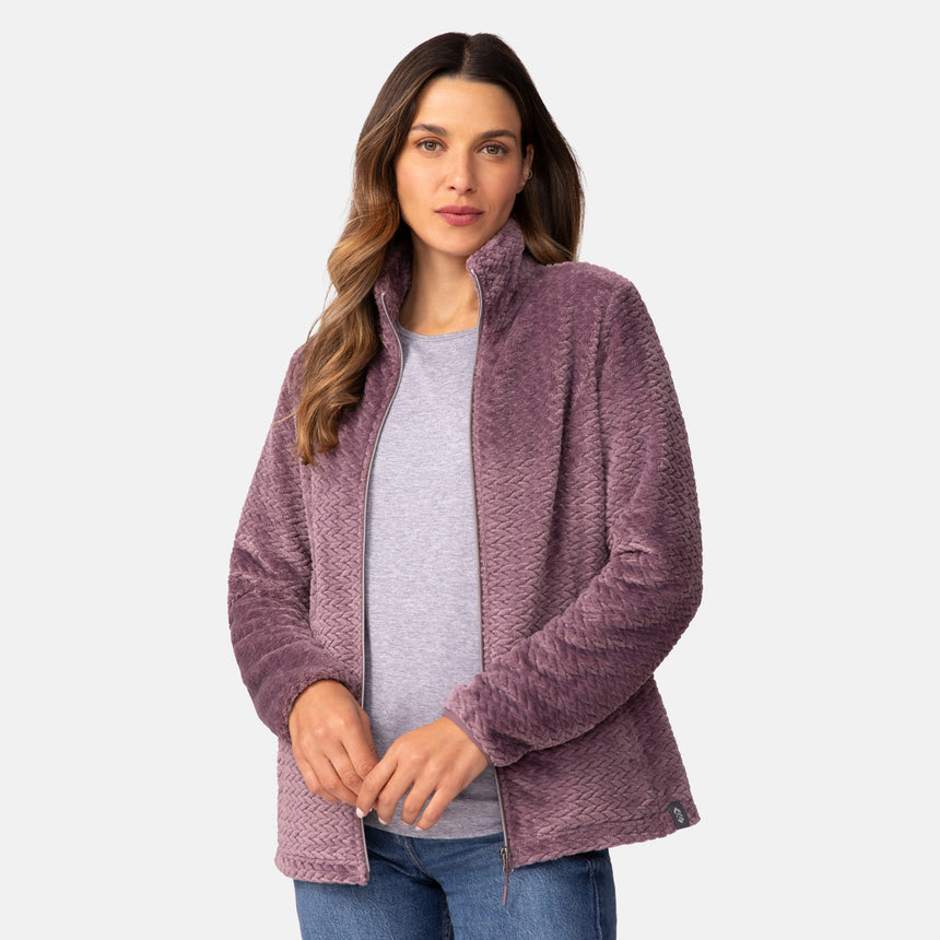 A woman wearing a plum-colored Women’s Cable Braided Butter Pile® Jacket over a grey t-shirt and jeans.