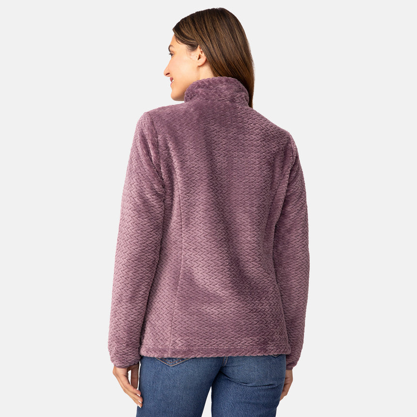 A woman seen from the back wearing a purple Women’s Cable Braided Butter Pile® Jacket with a high collar and blue jeans.