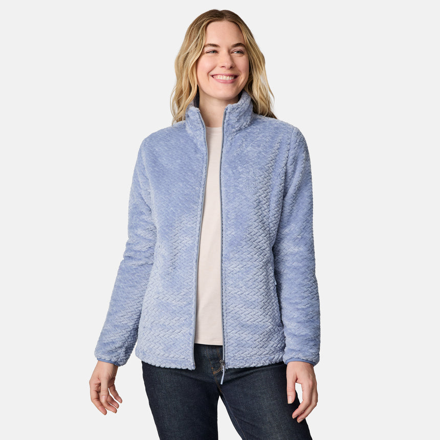 A woman wears a super soft, light blue Women’s Cable Braided Butter Pile® Jacket with a zip front and a quilted, braided texture.