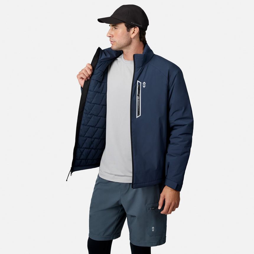 Male model in navy Ace Puffer Jacket unzipping to reveal quilted blue interior lining.
