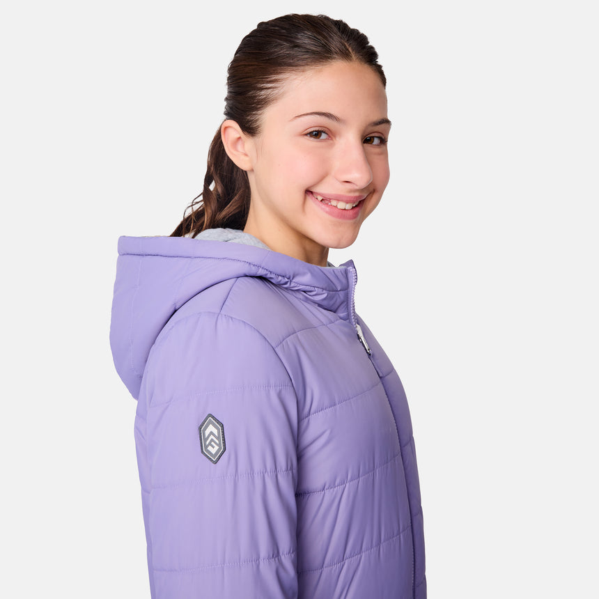 A young person with long brown hair smiles while wearing the Girls' Poofie Reversible Puffer Jacket from Clearance. Made from recycled polyester, this light purple, water-resistant girls' jacket stands out against a plain white background.