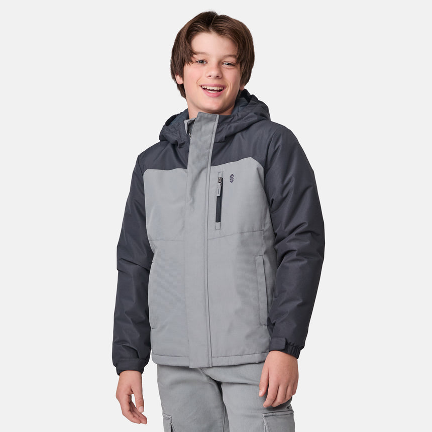 A smiling boy wears the Clearance Boys' Mount Avon Midweight Jacket in gray and dark gray, featuring recycled insulation, along with gray pants, standing against a plain white background.