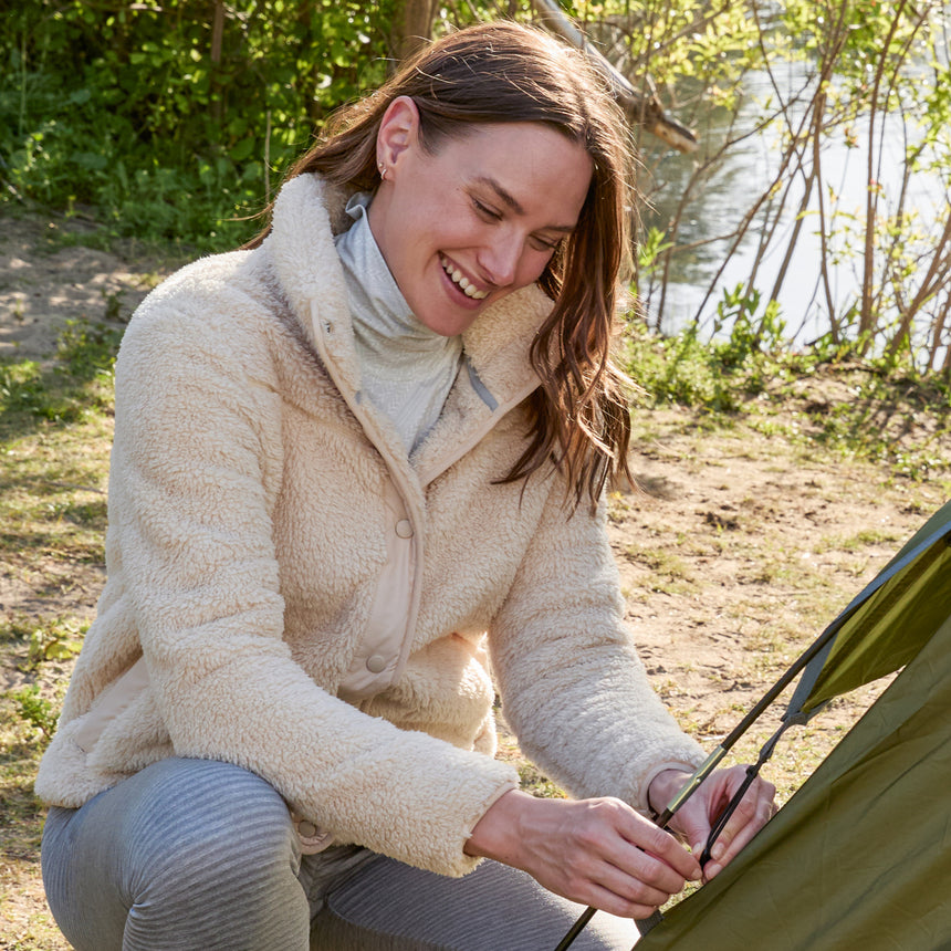 Woman wearing Free Country Women's Sherpa Butter Pile® Button Front Jacket in white  with a full front button opening, stand collar, lower pockets, and soft butter pile fabric. light grey background. Perfect women’s jacket for fall weather.