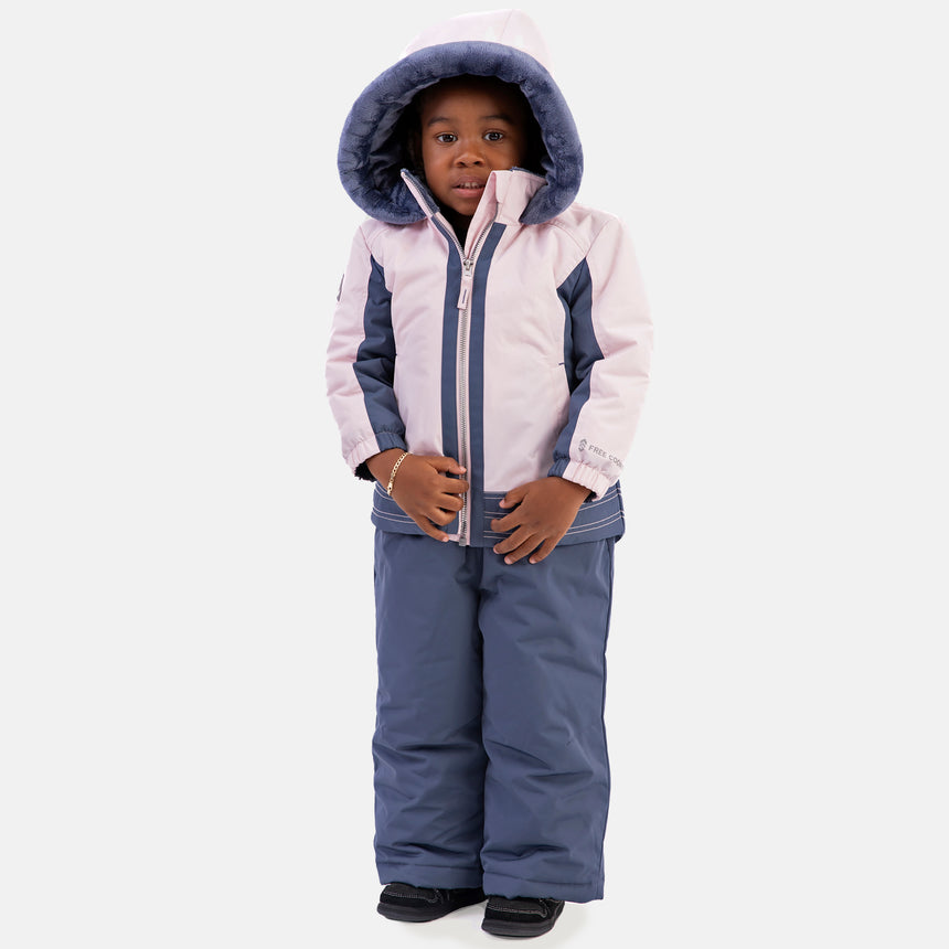 Young girl wearing the Free Country Girls' Toddler Boarder Jacket and Bib Pant Set, featuring a light pink and navy hooded jacket with Butter Pile® lining and matching navy snow pants, designed for winter play.