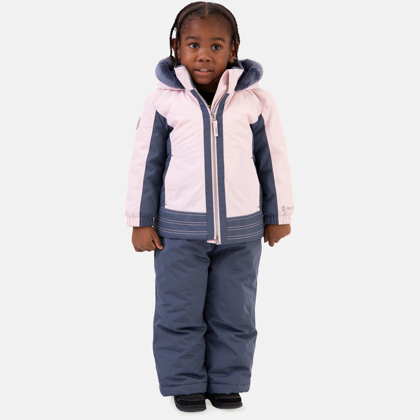Young girl wearing the Free Country Girls' Toddler Boarder Jacket and Bib Pant Set, featuring a light pink and navy hooded jacket with Butter Pile® lining and matching navy snow pants, designed for winter play.