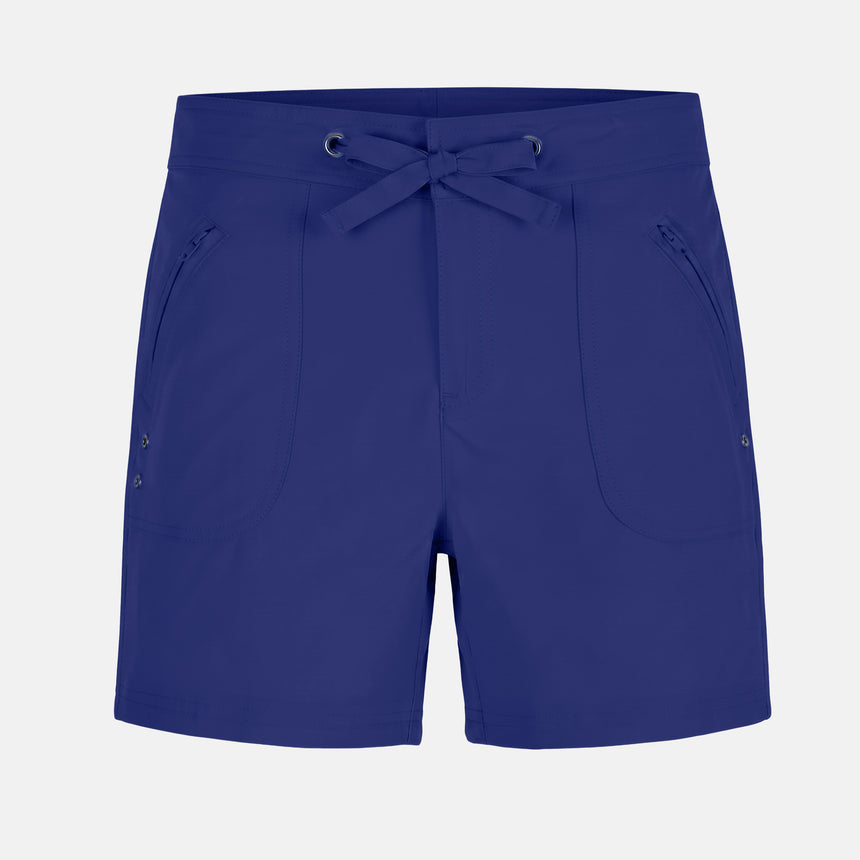 The Free Country Women's 5" Bermuda Board Short in navy features a drawstring waistband, two zippered front pockets, a small logo at the left hem, and is made from quick-drying fabric. Shorts are shown laid flat on a light background.