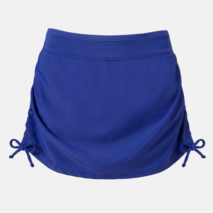 The Free Country Women's Side Shirred Swim Skirt, featuring adjustable side ties, a wide waistband, and a built-in brief, is shown in navy blue on a plain white background.
