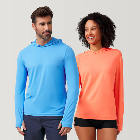 Woman wearing Free Country Everybody SunFree UPF Hoodie in Papaya, size S, Man wearing Free Country Everybody SunFree Hoodie in Sky size M, made from moisture wicking stretch UPF performance fabric featuring  an attached hood