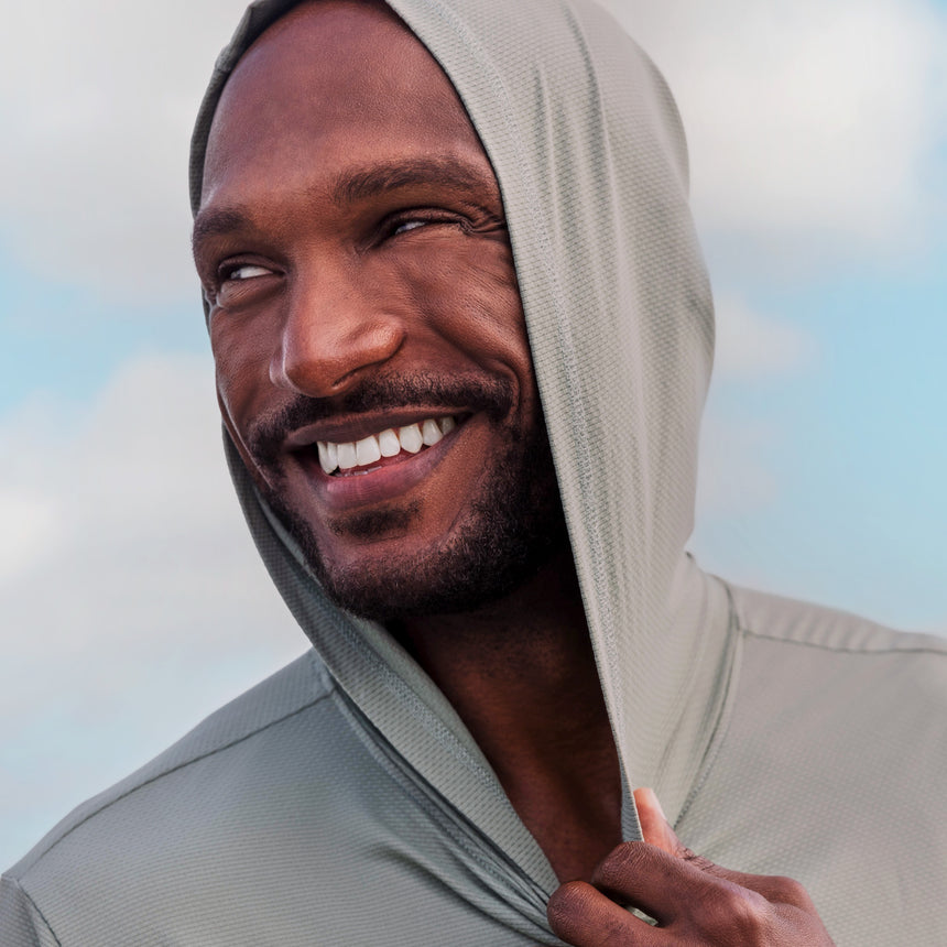 Man wearing Free Country The Everybody SunFree UPF Hoodie in Silver, size M, made from moisture wicking stretch UPF performance fabric featuring  an attached hood #color_silver