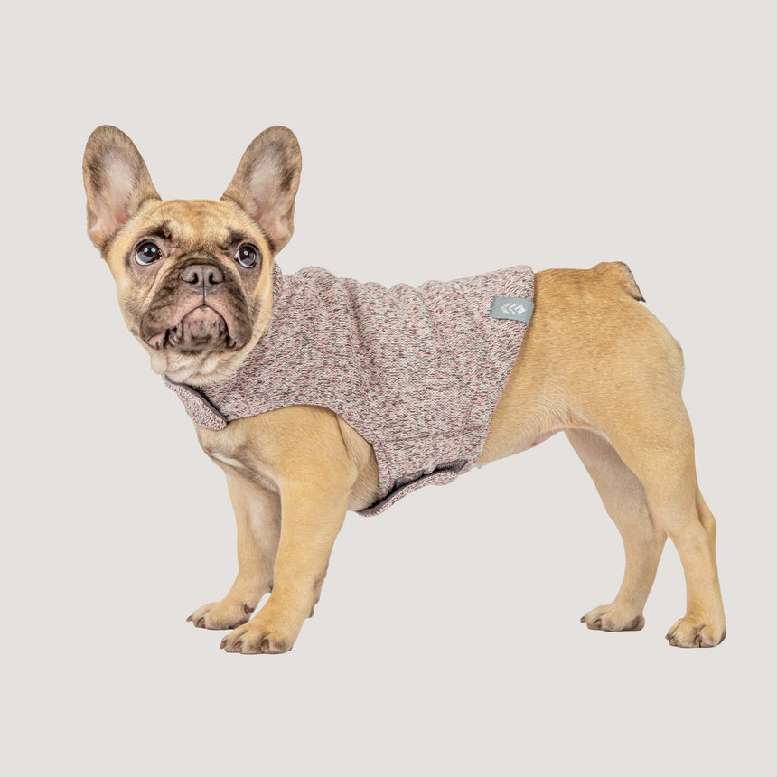 French Bulldog wearing the Free Country Dog Mountain Fleece Jacket in light pink textured fleece, designed to keep dogs warm while providing a comfortable fit, shown against a plain background.