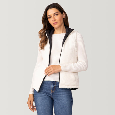 A woman wears the Clearance Women's Cascade Canvas 3-in-1 Systems Jacket over a ribbed white sweater and blue jeans, standing against a light gray background.