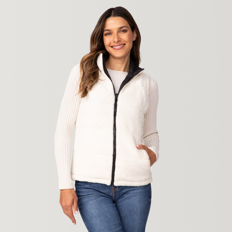A woman smiles with one hand in her pocket, wearing the Clearance Women's Cascade Canvas 3-in-1 Systems Jacket over a long-sleeve top and blue jeans against a plain light gray background.
