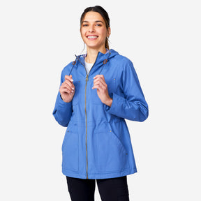 A woman wearing the Clearance Women's Lightweight Cascade Canvas Jacket, featuring large front pockets and a zipper, smiles while standing against a plain white background.