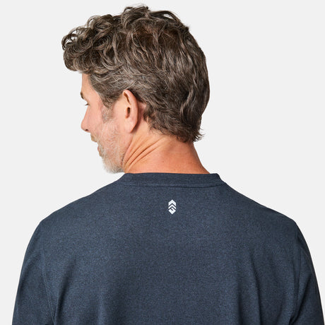 [Kolby is 6'2" wearing size M.] Man wearing a navy long-sleeve shirt on a white background