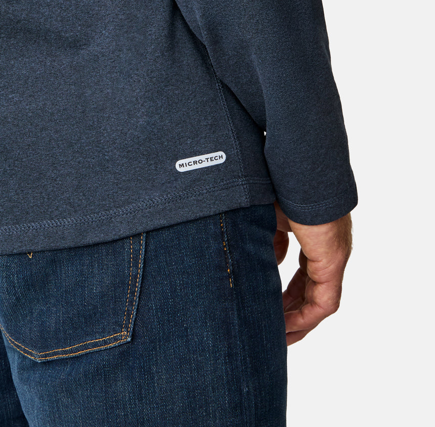 [Kolby is 6'2" wearing size M.] Man wearing a navy long-sleeve shirt on a white background