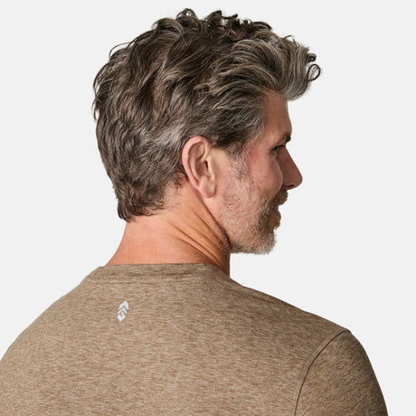 [Kolby is 6'2" wearing size M.] Man wearing a brown long-sleeve shirt on a white background