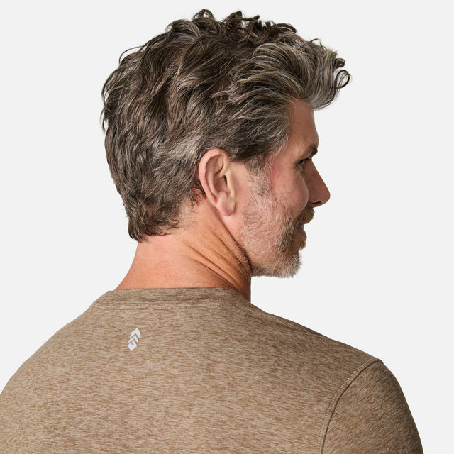 [Kolby is 6'2" wearing size M.] Man wearing a brown long-sleeve shirt on a white background