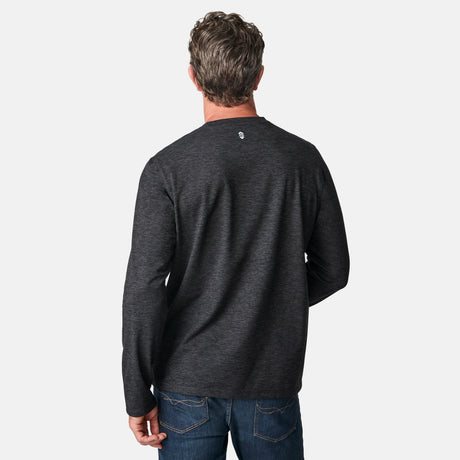 [Kolby is 6'2" wearing size M.] Man wearing a dark gray long-sleeve shirt on a white background