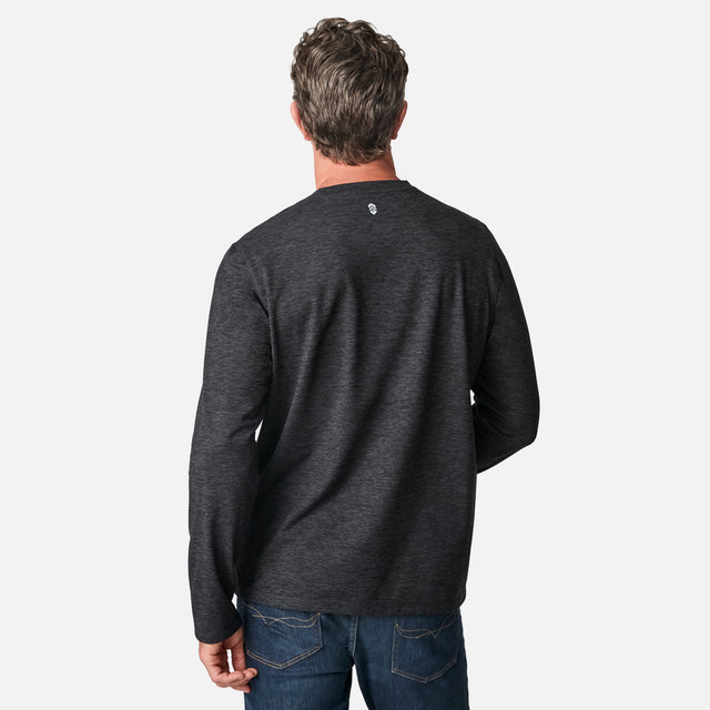 [Kolby is 6'2" wearing size M.] Man wearing a dark gray long-sleeve shirt on a white background