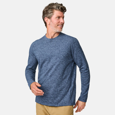 [Kolby is 6'2" wearing size M.] Man wearing a blue long-sleeve shirt on a white background