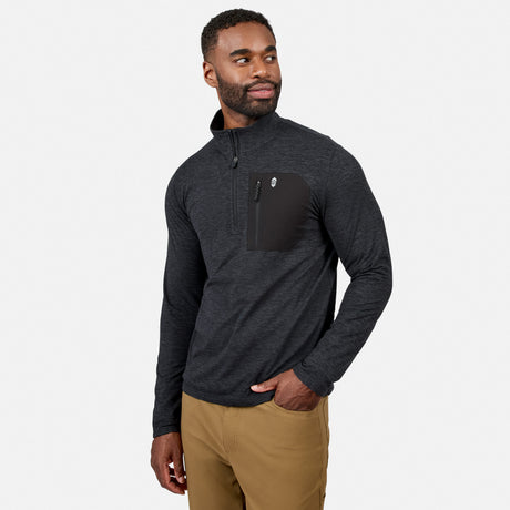 [Model is wearing size M.] A man wearing a dark gray heathered quarter-zip pullover with a black chest pocket, paired with tan pants, photographed against a light gray studio background.