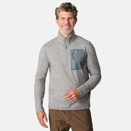 [Kolby is 6'2" wearing size M.] Men’s Free Country gray quarter-zip pullover with zippered chest pocket in contrasting fabric—paired with brown pants. Designed for lightweight layering, combining casual comfort and outdoor-ready functionality.