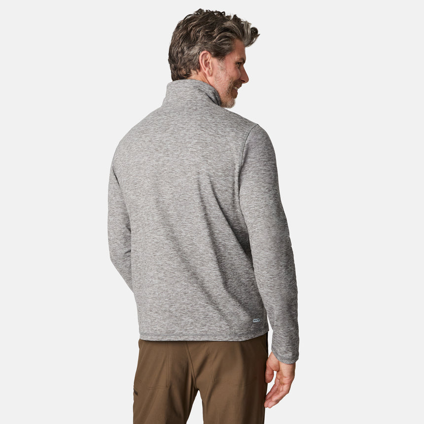 [Kolby is 6'2" wearing size M.] Men’s Free Country gray quarter-zip pullover with zippered chest pocket in contrasting fabric—paired with brown pants. Designed for lightweight layering, combining casual comfort and outdoor-ready functionality.