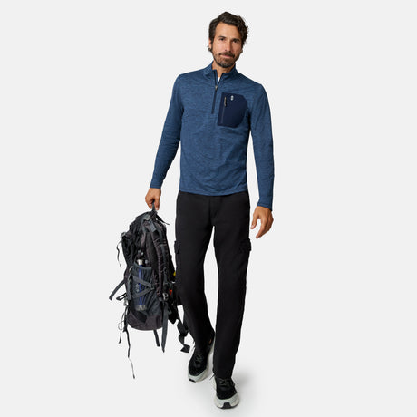 [Model is wearing size M.] A man wearing a heathered blue quarter-zip pullover, black cargo pants, and black sneakers is shown against a light gray background, holding a black hiking backpack.