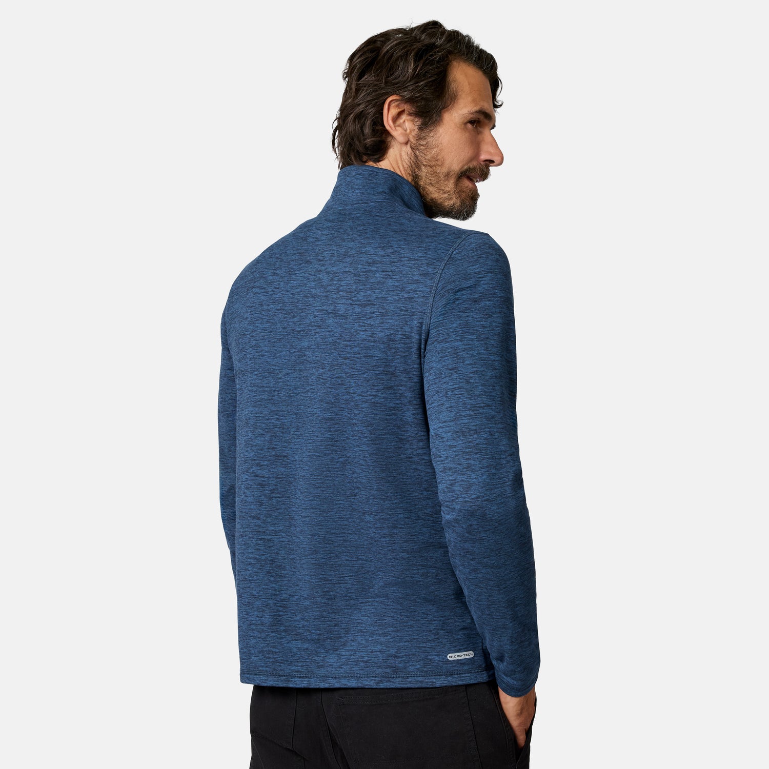 [Model is wearing size M.] A man wearing a heathered blue quarter-zip pullover jacket, shown from a three-quarters back view against a light gray studio background.