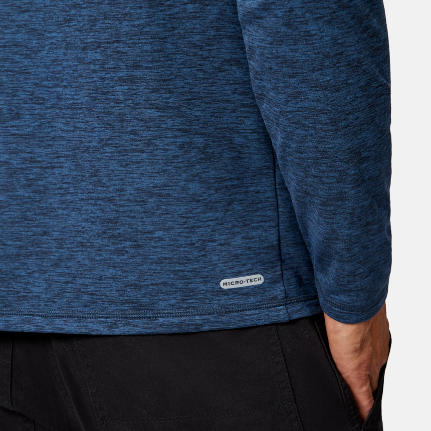 [Model is wearing size M.] Close-up of a person wearing a heathered blue long-sleeve top and black pants, with a small MICRO-TEC label near the hem.