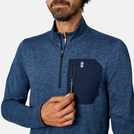 [Model is wearing size M.] A close-up of a man wearing a blue heathered quarter-zip pullover with a dark navy chest pocket and a white logo, set against a plain light gray background.