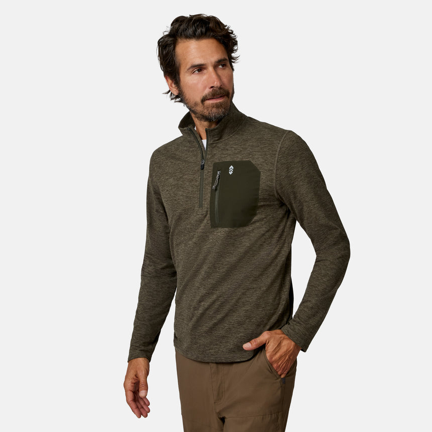 [Model is wearing size M.] A man wearing a dark olive green heathered quarter-zip pullover with a contrasting dark green chest pocket, paired with brown pants, against a light gray background.
