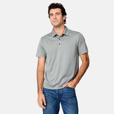 [Jacob is 6’1.5" wearing size M] Man wearing a gray striped polo shirt and blue jeans on a white background