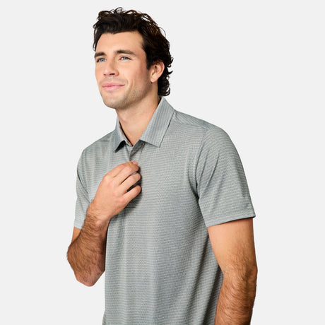 [Jacob is 6’1.5" wearing size M] Man wearing a gray striped polo shirt and blue jeans on a white background