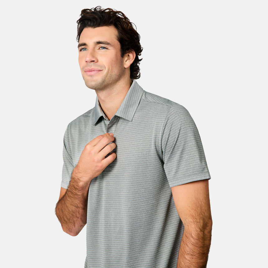 [Jacob is 6’1.5" wearing size M] Man wearing a gray striped polo shirt and blue jeans on a white background