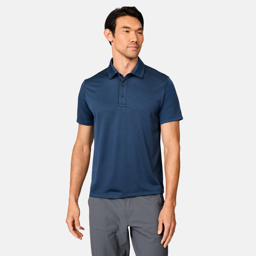 [Scott is 6’3" wearing size M] Man wearing a blue polo shirt and gray pants on a white background